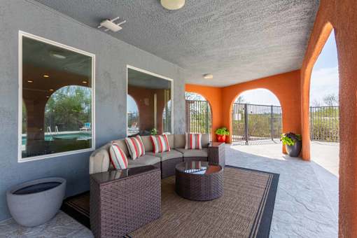 A patio with a couch, table, and a potted plant at Elevation Apartments, Tucson, AZ, 85718