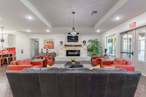 Community Clubroom with Large Seating Area with TV's and Chairs  at Legacy Brooks, San Antonio