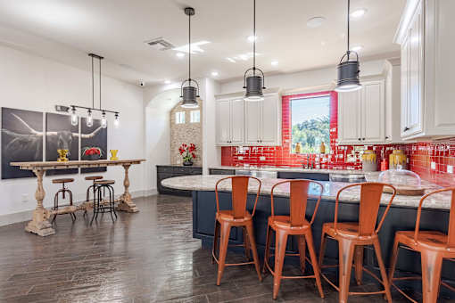 Clubroom Kitchen and Dining Room with Stools and Chairs  at Legacy Brooks, 78223