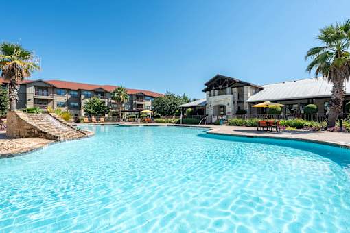 Swimming Pool with Leasing Office in Background  at Legacy Brooks, San Antonio, TX, 78223