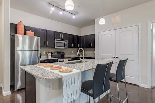 Kitchen Island with Stainless Steel Appliances and Cabinetry  at Legacy Brooks, San Antonio, 78223