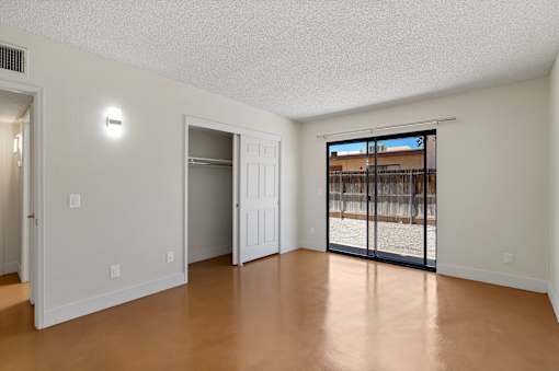 A room with a sliding glass door leading to a balcony at San Xavier Casitas, Arizona, 85716