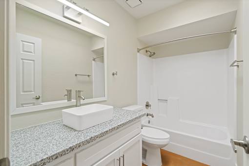 A white bathroom with a sink, toilet, and bathtub at San Xavier Casitas, Tucson, AZ