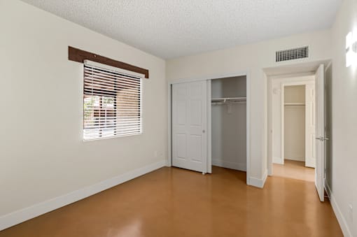 A bedroom with a closet and window at San Xavier Casitas, Arizona
