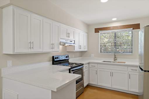 A kitchen with white cabinets and a stove top oven at San Xavier Casitas, Tucson