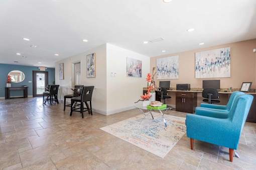 A living room with a blue chair and a rug with a drawing on it.