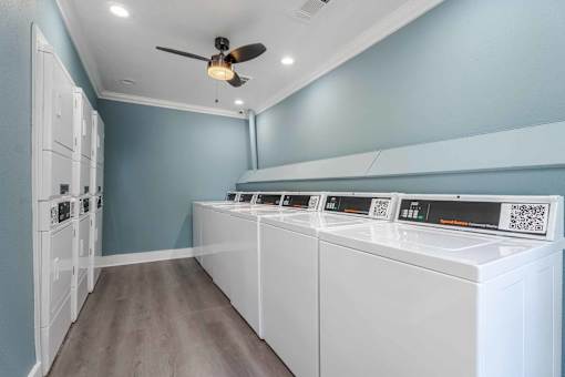 A row of washing machines in a laundry room.