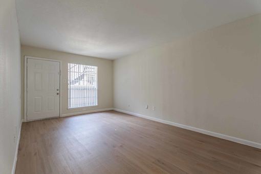 A room with a white door and a window with blinds.