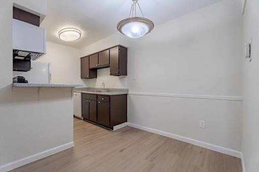 A kitchen area with a sink and cabinets.