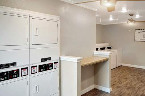 A laundry room with washers and dryers.