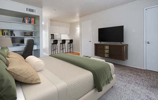 A bedroom with a bed, a desk, and a TV.