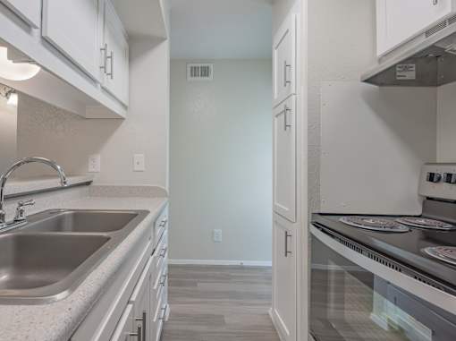 Kitchen with white cabinets and stainless steel appliances  at Willow Oaks, Bryan, 77802