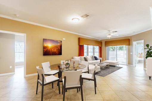 a living room and dining room with a table and chairs