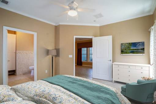 a bedroom with a bed and a ceiling fan
