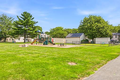 A park with a playground and a walking path.