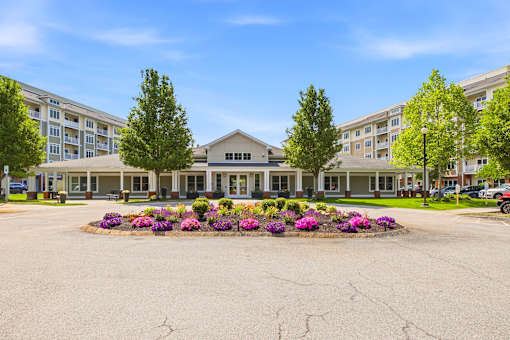 A large building with a flower bed in front of it.