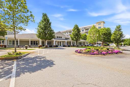 A large building with a parking lot in front of it.
