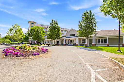 A large building with a driveway in front of it.