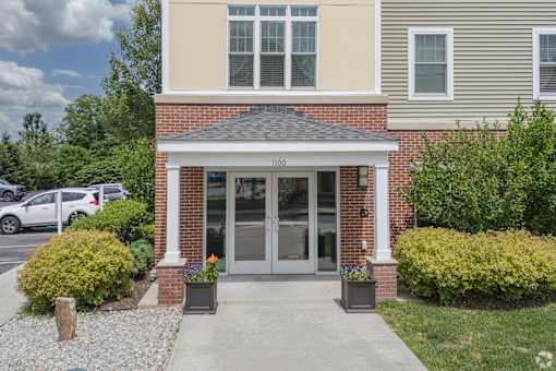 A house with a grey front door and a small porch.