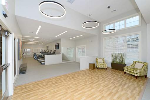 A spacious room with wooden floors and white walls at Axis at Lakeshore Apartments, Massachusetts, 02324