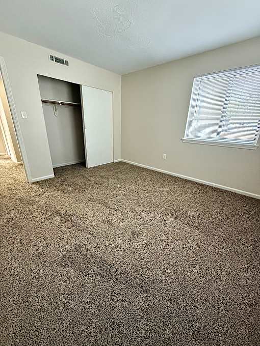 Room with carpet and a door to a closet at Hidden Brook Apartment Homes Apartments, New Bedford, Massachusetts