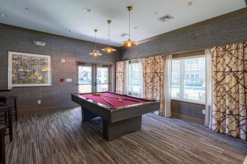 A room with a pool table and a painting on the wall at Axis at Lakeshore Apartments, Bridgewater, MA