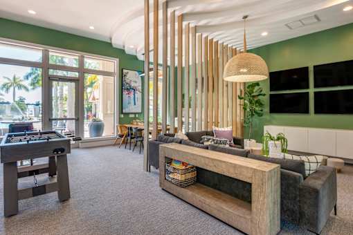 A room with a green wall and a wooden table.