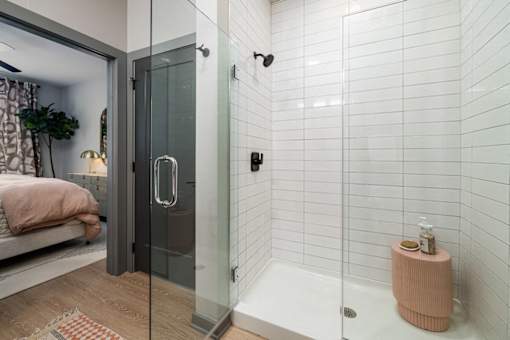a white bathroom with a shower and a bed