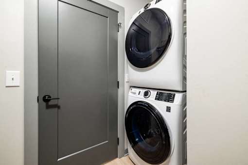 a small laundry room with a washing machine and a door