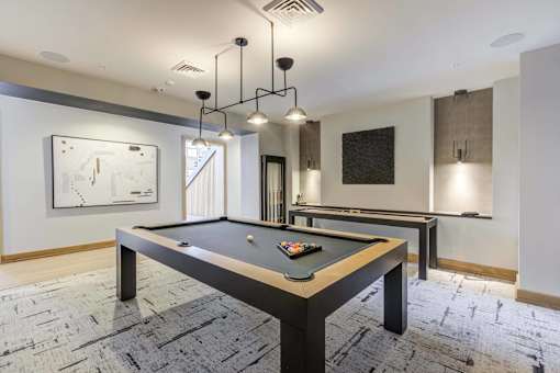 a billiards table in a game room with lights