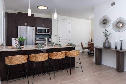 A kitchen with brown cabinets and a white fridge.