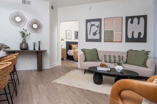 A living room with a couch, a table, and a chair.