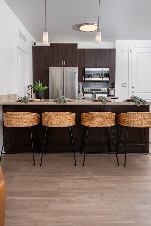 A kitchen with a bar stool and a countertop.
