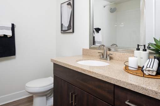 A bathroom with a white toilet and a sink.