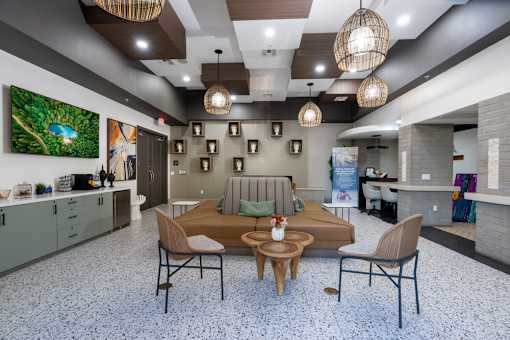 A modern living room with a dining table and chairs.