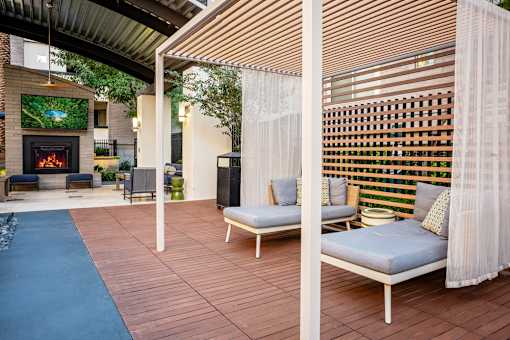 A patio with a fireplace and a sofa.