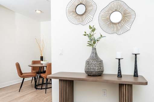 A dining room with a table, chairs, and decorative items.