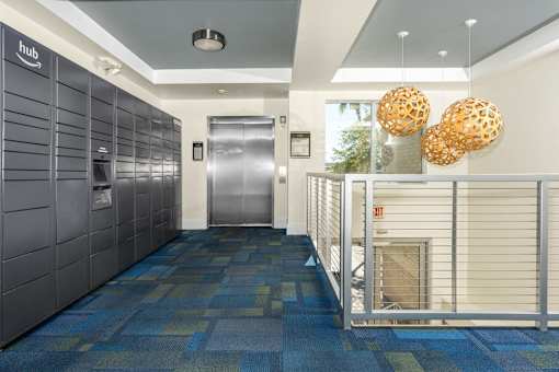A hallway with a blue carpet and a white wall with a sign that says "hub".
