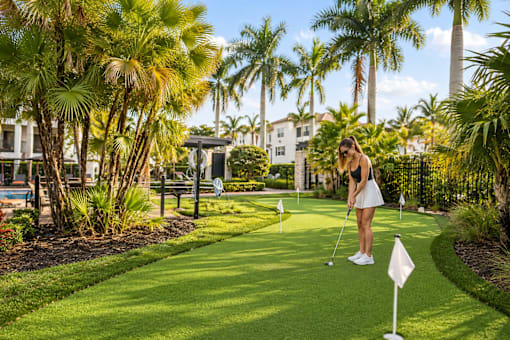 A woman is playing golf on a sunny day.