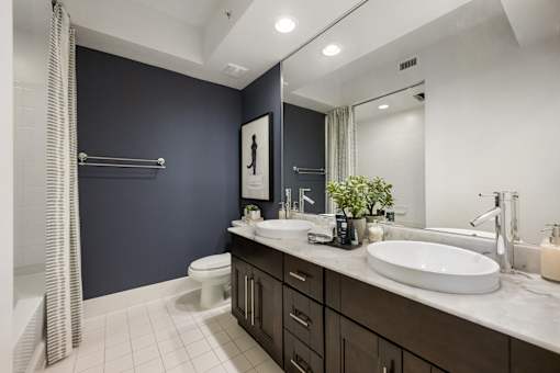 A bathroom with a white sink and a white toilet.