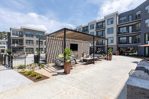 an outdoor patio with tables and chairs in an apartment building