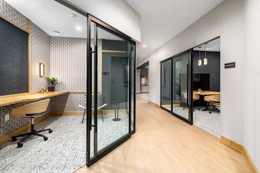 a conference room with glass doors and a wooden floor