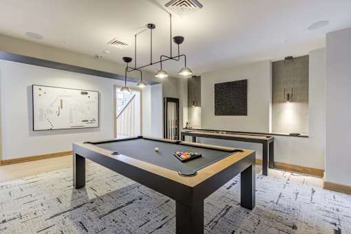 a billiards table in a game room with lights