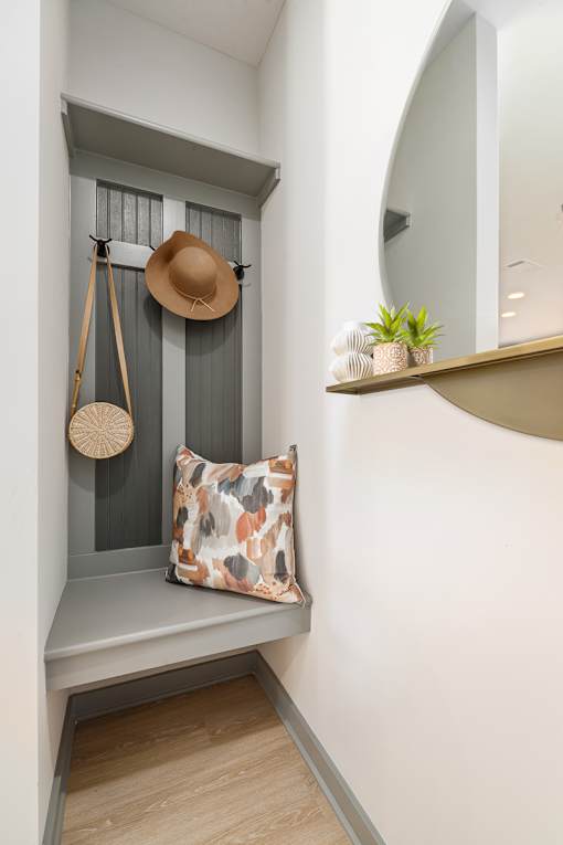 a hat and a purse hanging on a shelf in a stairwell