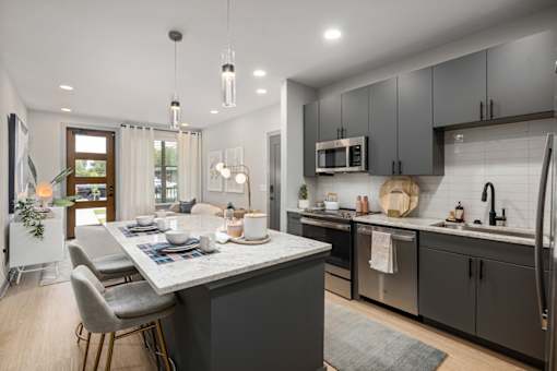 an open kitchen and dining area with a table and chairs