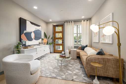 a living room with a couch and two chairs