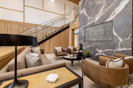 the lobby of a hotel with couches and a table