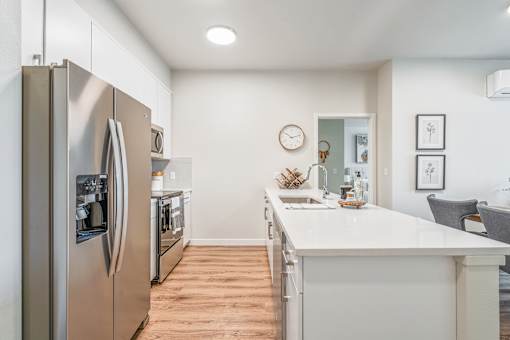 a kitchen with white quartz countertops and stainless steel appliances