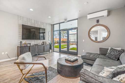 a living room with grey couches and a round coffee table