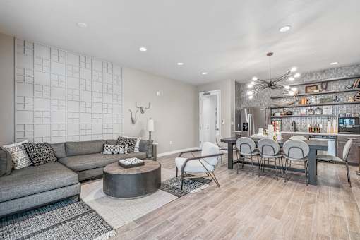 a living room with a couch and a table with chairs